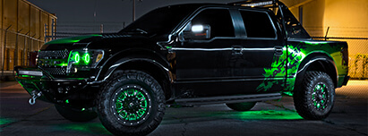 Ford F150 Raptor in black with green halo headlights